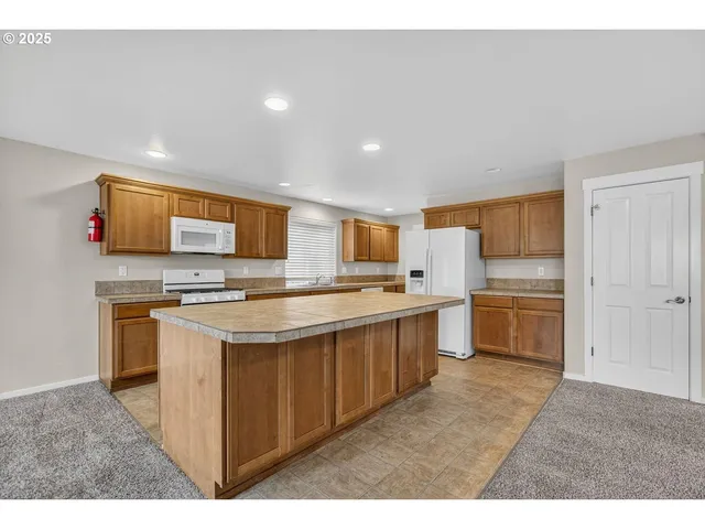 a kitchen with stainless steel appliances a sink stove and cabinets