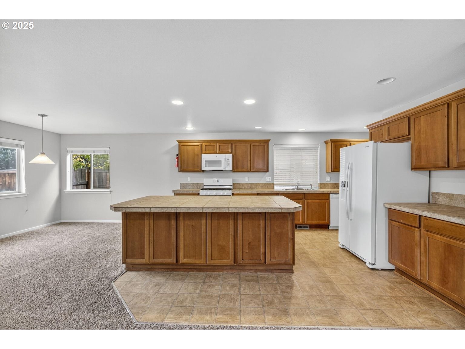 21154 Ritz Place Bend, OR 97702 - Photo 9 of 24 a view of kitchen with stainless steel appliances granite countertop a stove a sink dishwasher and a refrigerator with wooden floor