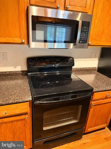 a stove top oven sitting inside of a kitchen