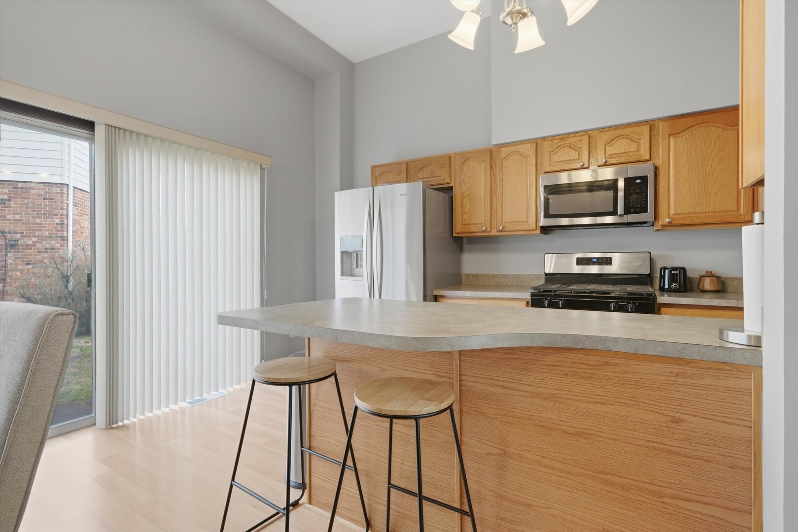 8820 Plainfield Road Brookfield, IL 60513 - Photo 15 of 49 a kitchen with stainless steel appliances a stove a sink a microwave a refrigerator and cabinets