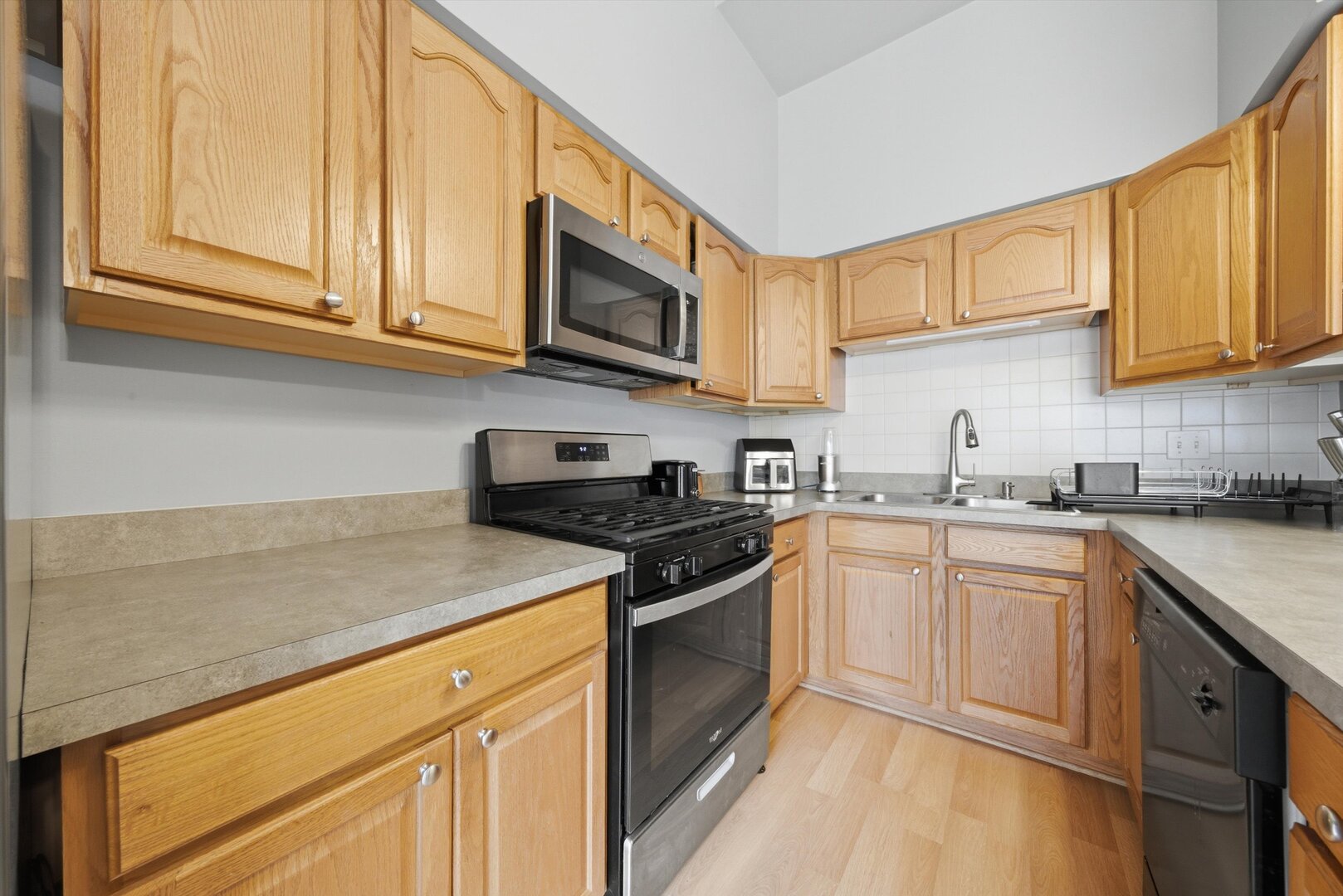 8820 Plainfield Road Brookfield, IL 60513 - Photo 17 of 49 a kitchen with stainless steel appliances granite countertop a sink stove and microwave