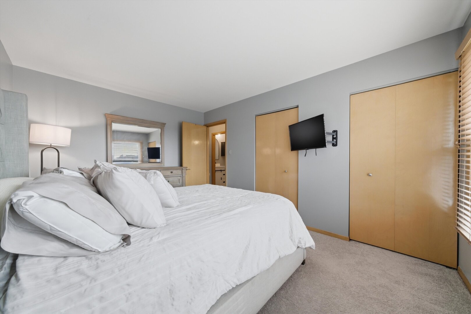 8820 Plainfield Road Brookfield, IL 60513 - Photo 23 of 49 a spacious bedroom with a bed and a flat screen tv