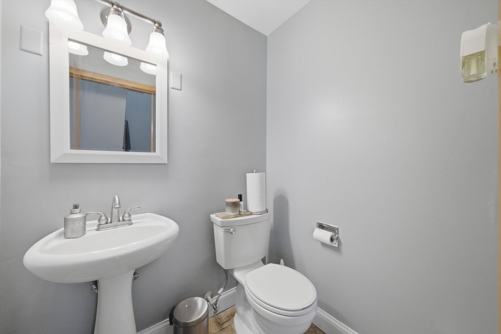 8820 Plainfield Road Brookfield, IL 60513 - Photo 31 of 49 a bathroom with a toilet sink and mirror