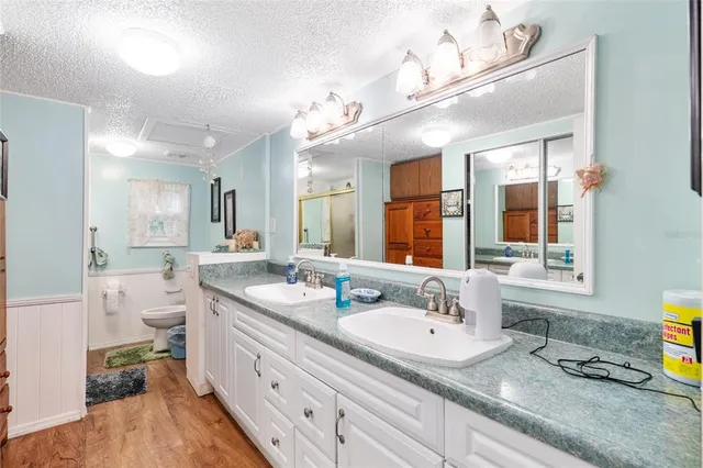 a white toilet sitting next to a bathroom sink