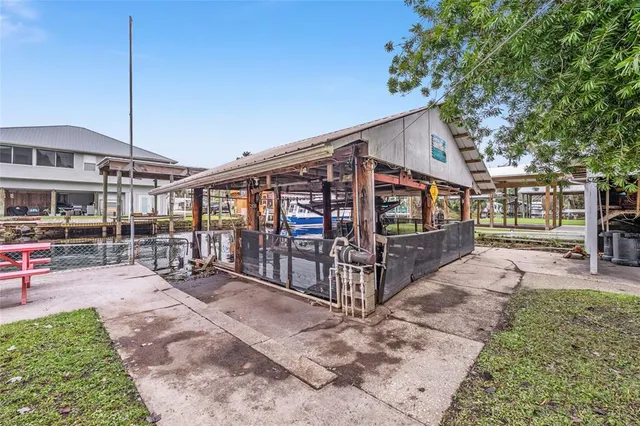 a swimming pool with outdoor seating and trees