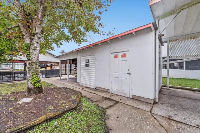 a view of a house with backyard and sitting area