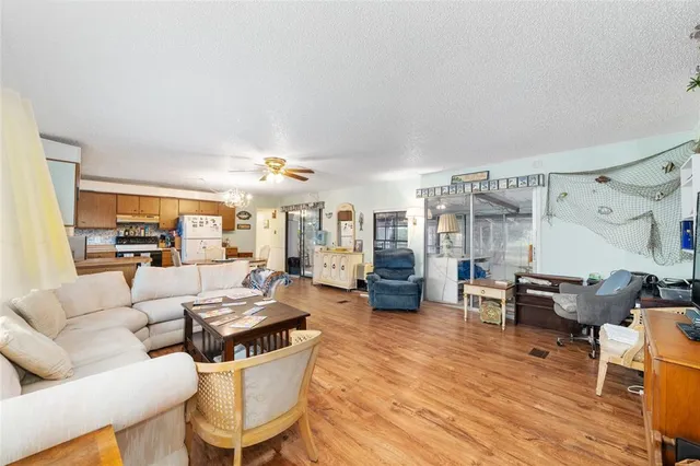a living room with furniture and view of kitchen