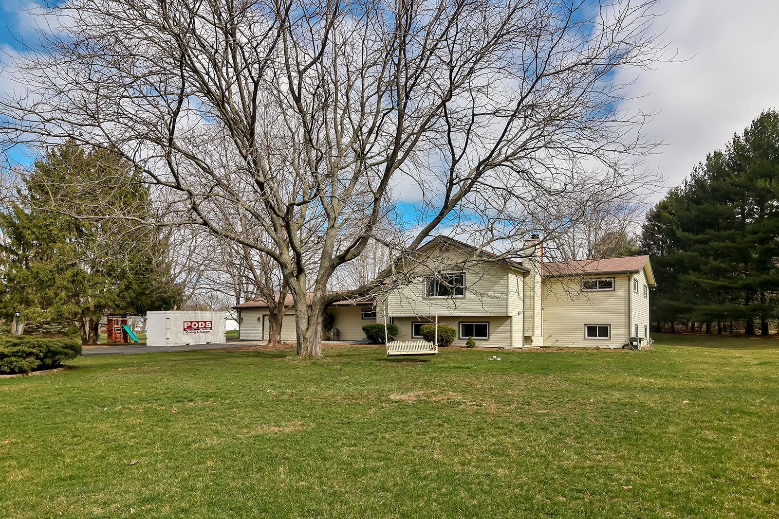 a front view of a building with a garden