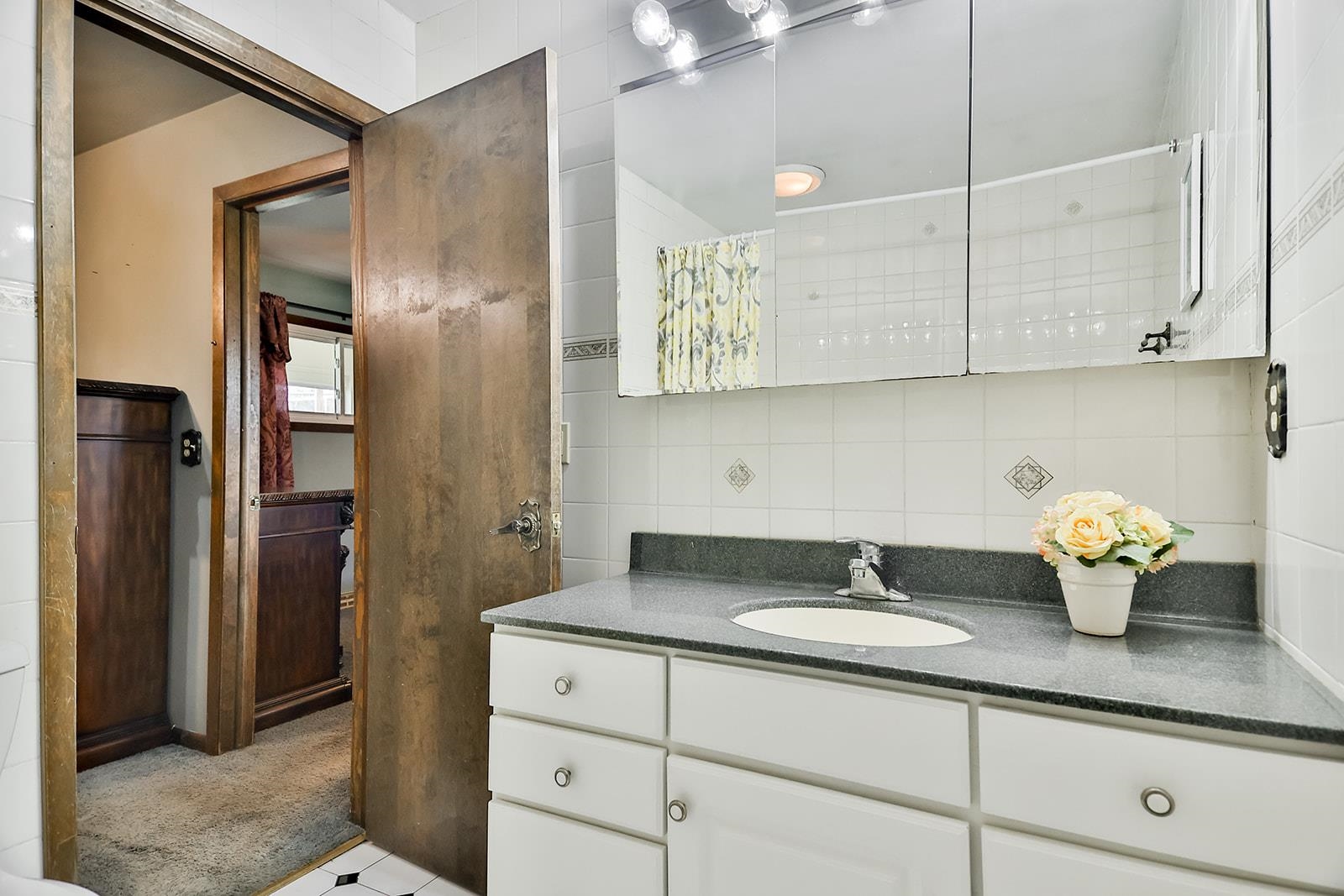 6855 Happy Acres Road Rockford, IL 61101 - Photo 20 of 39 a bathroom with a granite countertop sink and a mirror