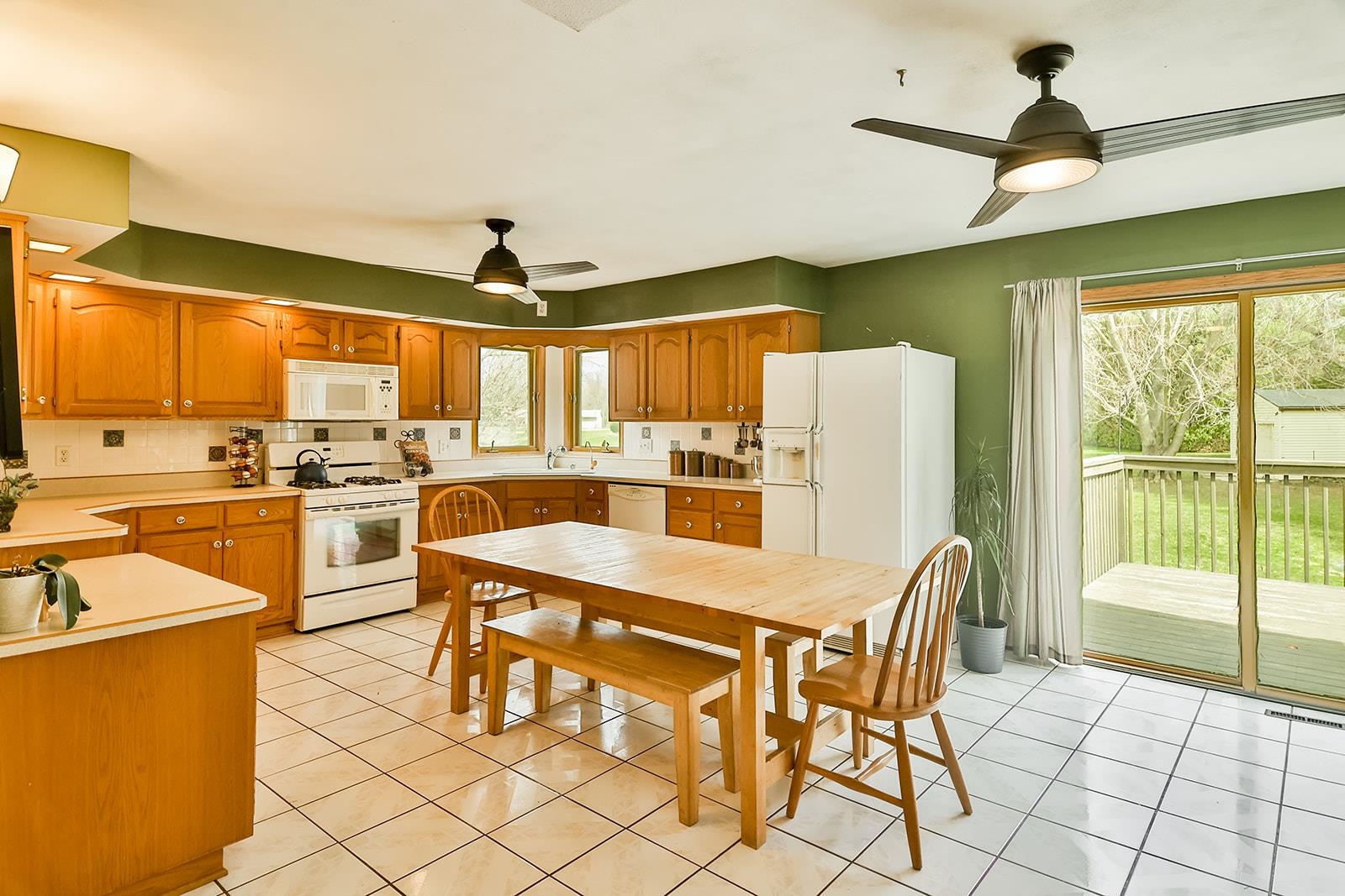 6855 Happy Acres Road Rockford, IL 61101 - Photo 25 of 39 a kitchen with a table chairs refrigerator and cabinets