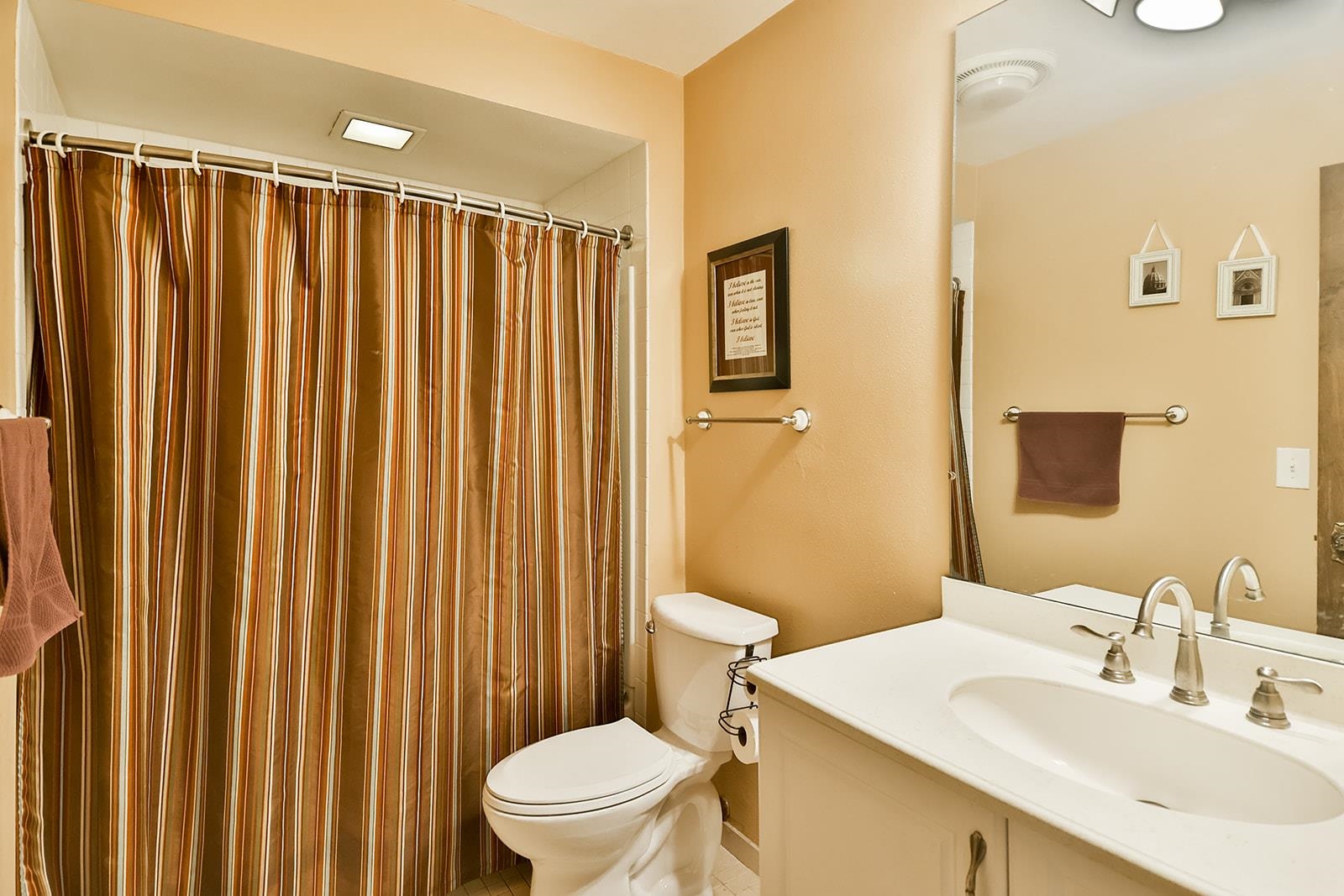 6855 Happy Acres Road Rockford, IL 61101 - Photo 30 of 39 a bathroom with a sink a toilet a mirror and shower curtain