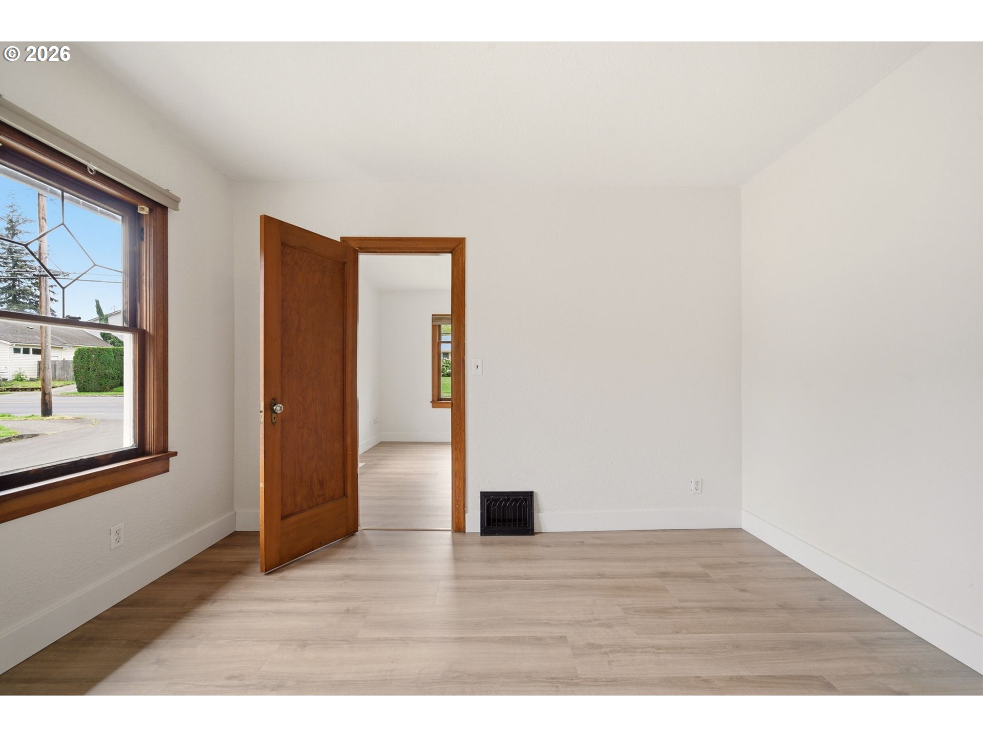 1804 Division Street Camas, WA 98607 - Photo 12 of 43 a view of an empty room with wooden floor and a window