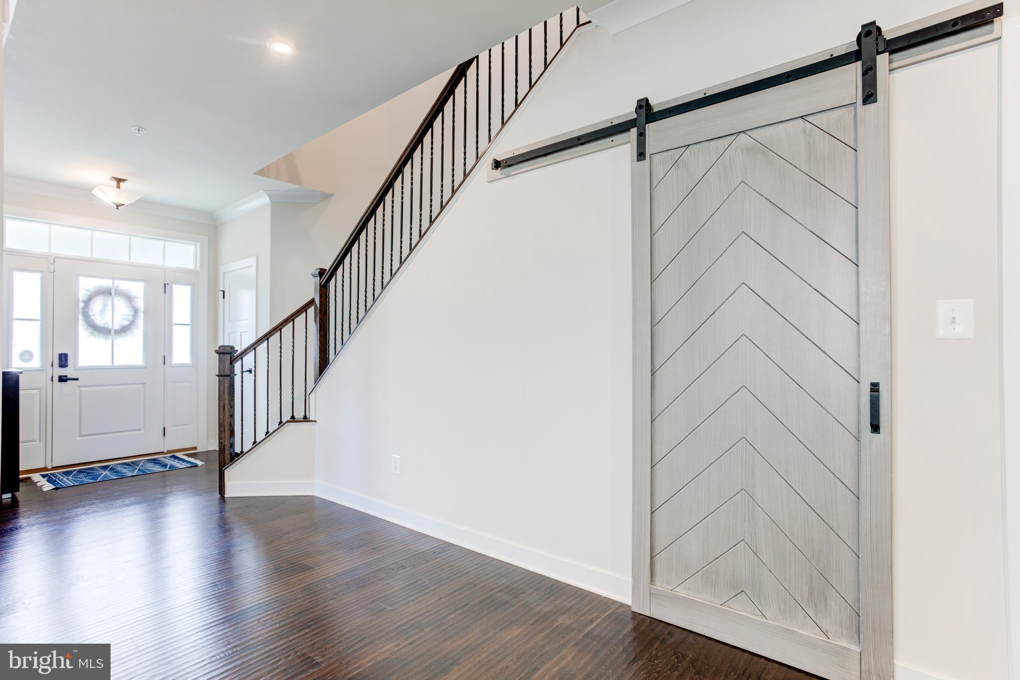 2346 Sweet Pepperbrush Loop Dumfries, VA 22026 - Photo 18 of 84 a view of hallway with stairs and wooden floor