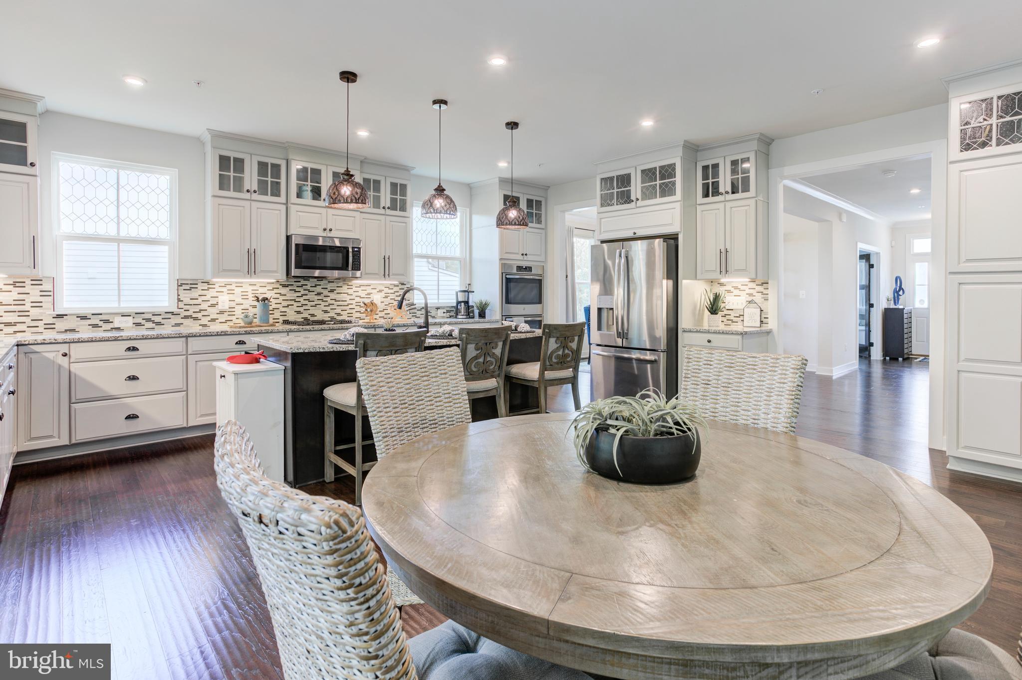 2346 Sweet Pepperbrush Loop Dumfries, VA 22026 - Photo 20 of 84 a kitchen with stainless steel appliances kitchen island granite countertop a stove refrigerator and cabinets