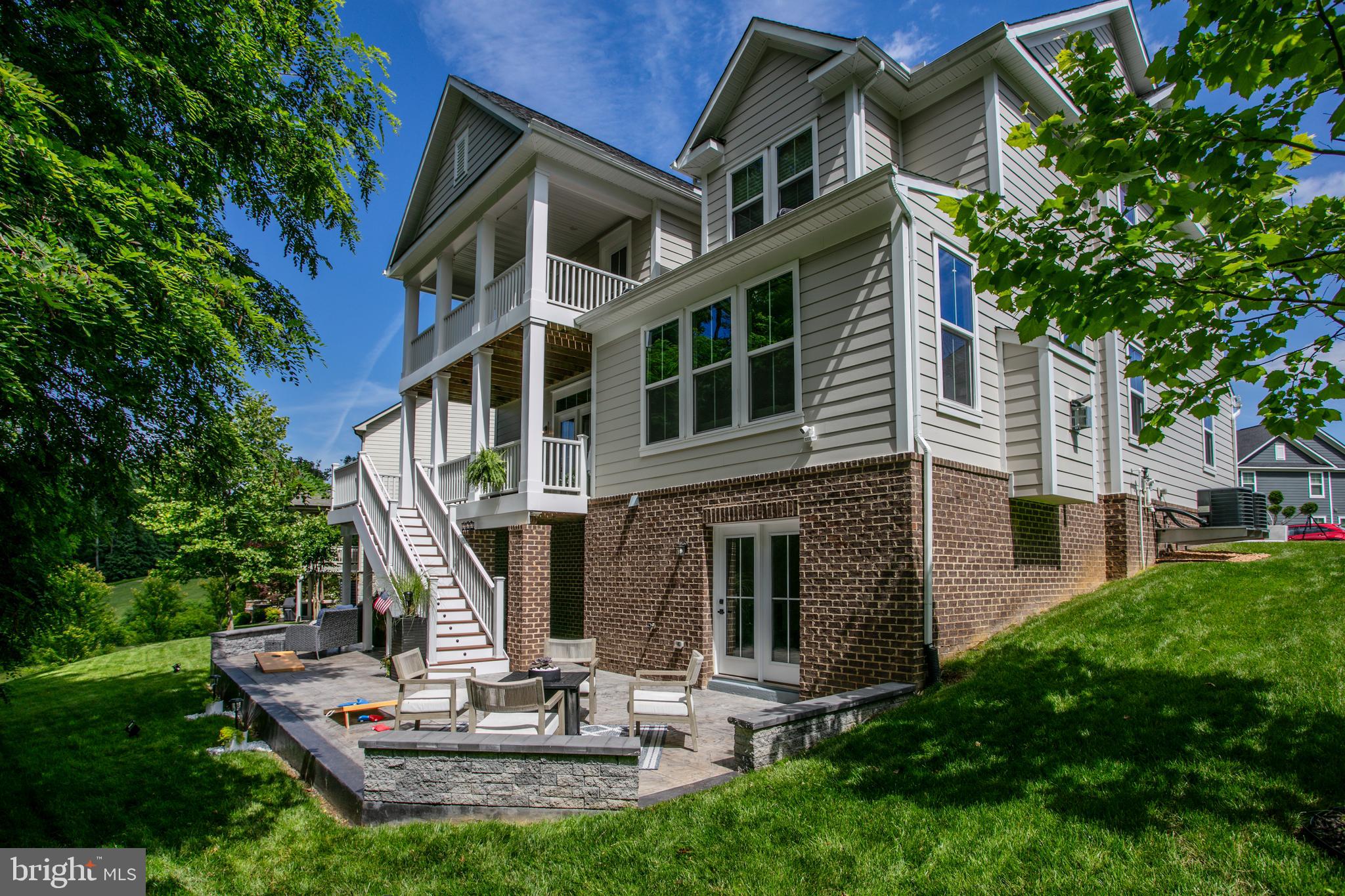 2346 Sweet Pepperbrush Loop Dumfries, VA 22026 - Photo 2 of 84 a front view of a house with a yard
