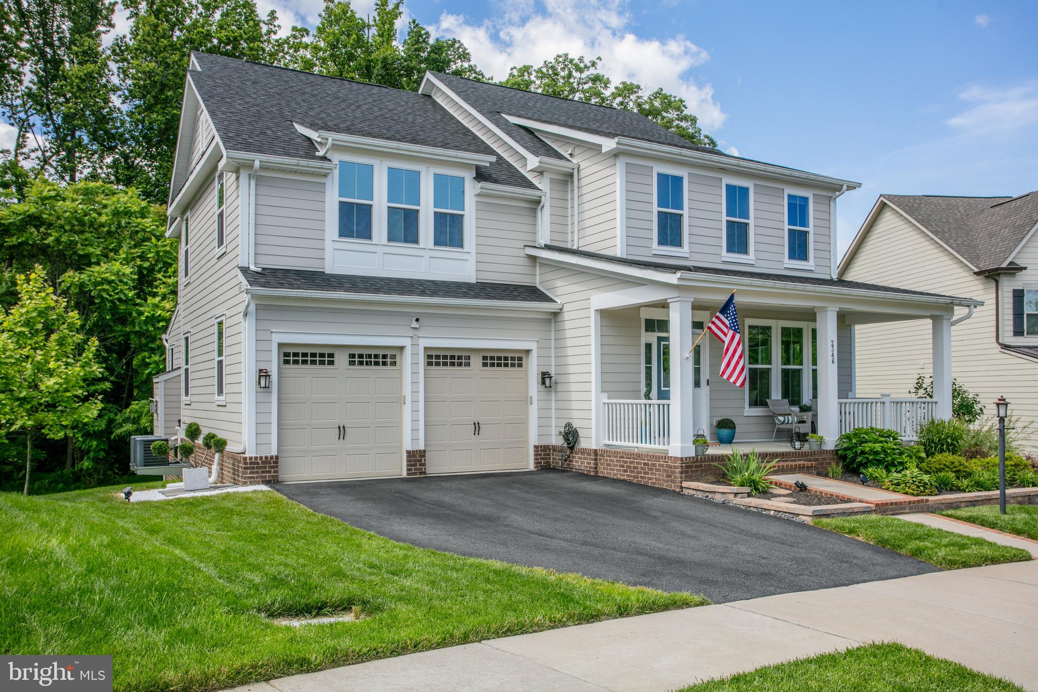 2346 Sweet Pepperbrush Loop Dumfries, VA 22026 - Photo 3 of 84 a front view of a house with a yard and garage