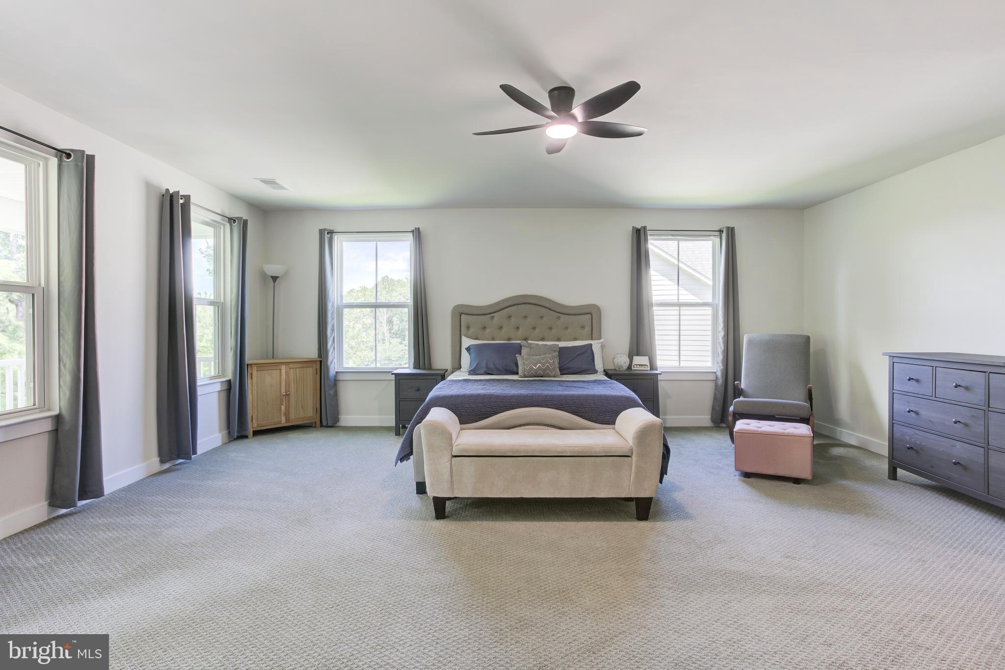 2346 Sweet Pepperbrush Loop Dumfries, VA 22026 - Photo 37 of 84 a bedroom with a bed and a chandelier