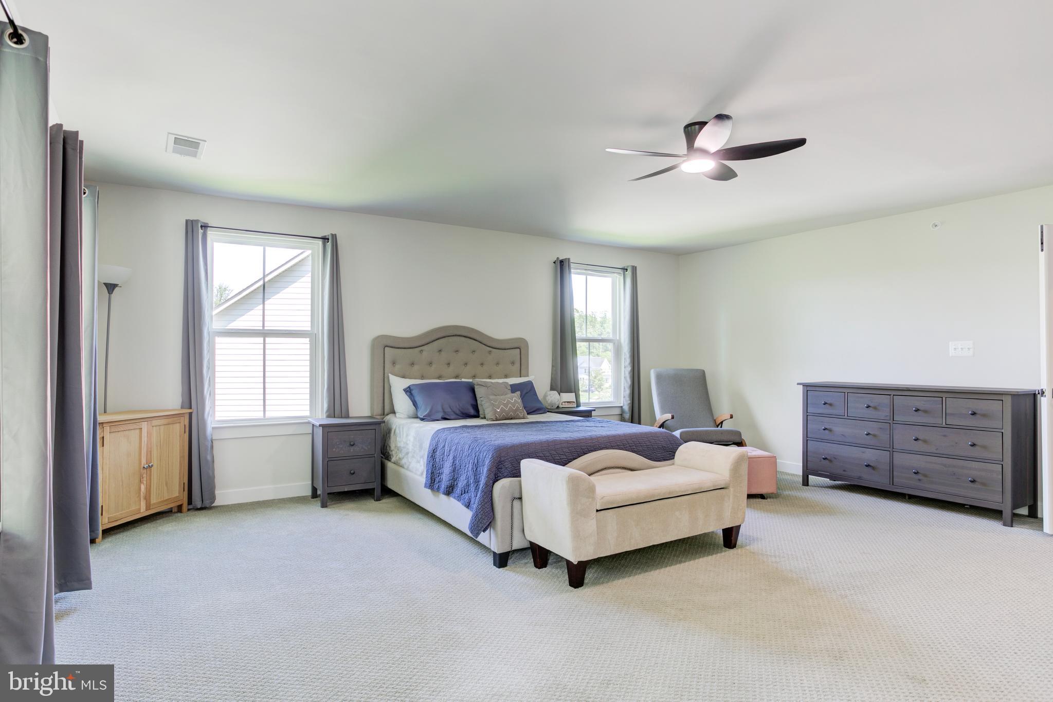 2346 Sweet Pepperbrush Loop Dumfries, VA 22026 - Photo 38 of 84 a spacious bedroom with a bed and a window