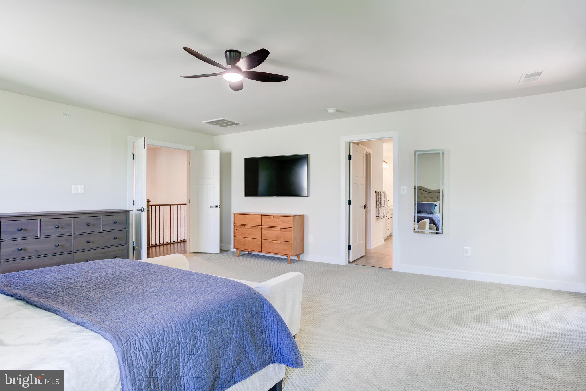 2346 Sweet Pepperbrush Loop Dumfries, VA 22026 - Photo 39 of 84 a spacious bedroom with a bed and a flat screen tv