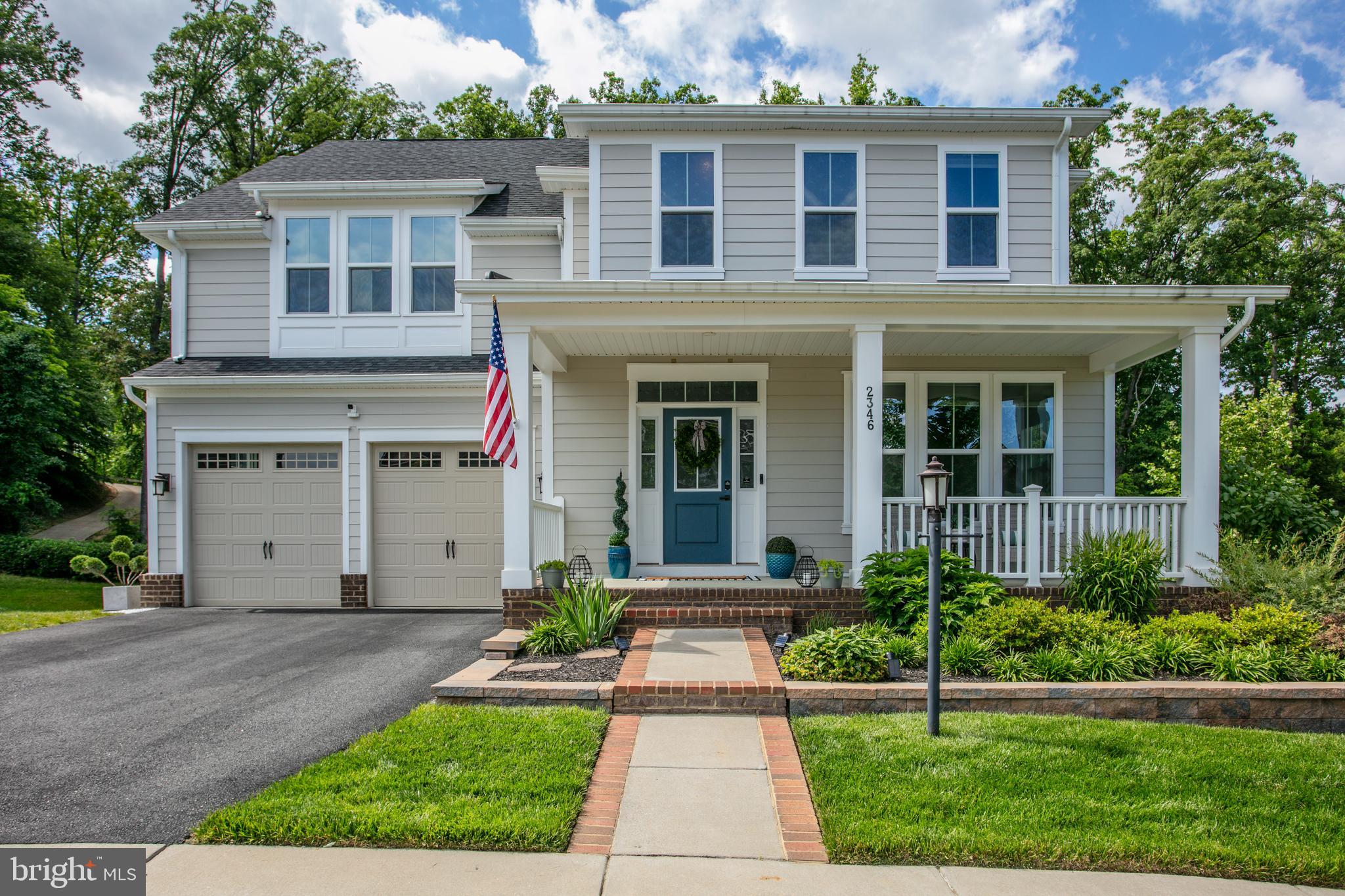2346 Sweet Pepperbrush Loop Dumfries, VA 22026 - Photo 4 of 84 a front view of a house with a yard and potted plants