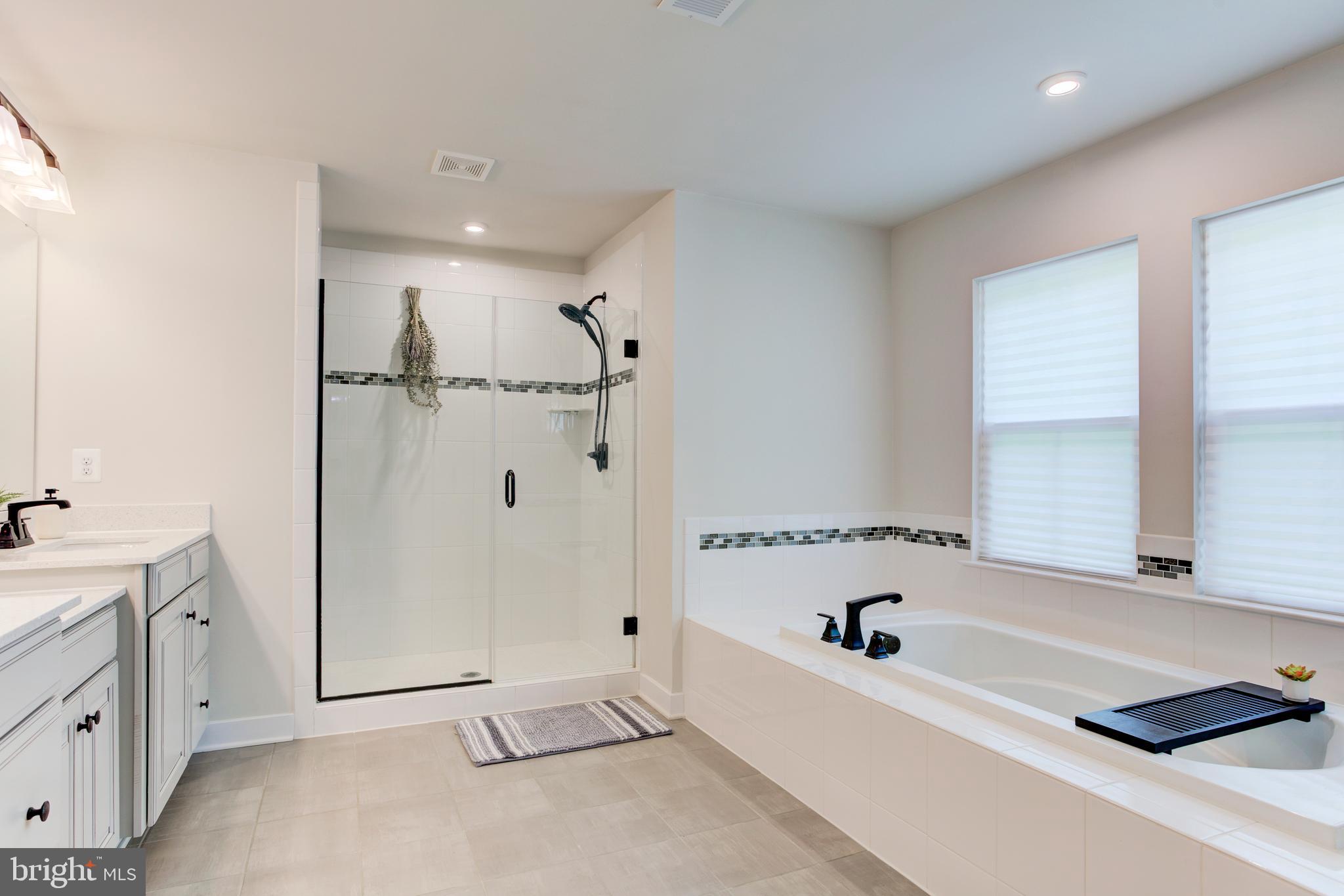 2346 Sweet Pepperbrush Loop Dumfries, VA 22026 - Photo 43 of 84 a bathroom with a bathtub and a shower