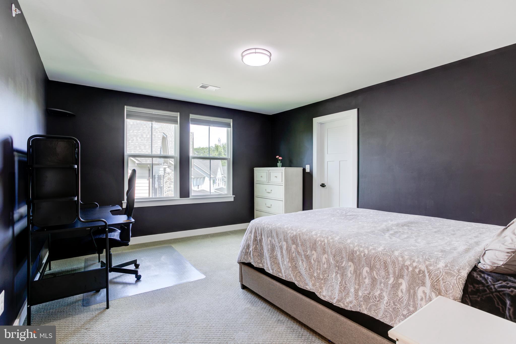 2346 Sweet Pepperbrush Loop Dumfries, VA 22026 - Photo 48 of 84 a spacious bedroom with a bed and a large window