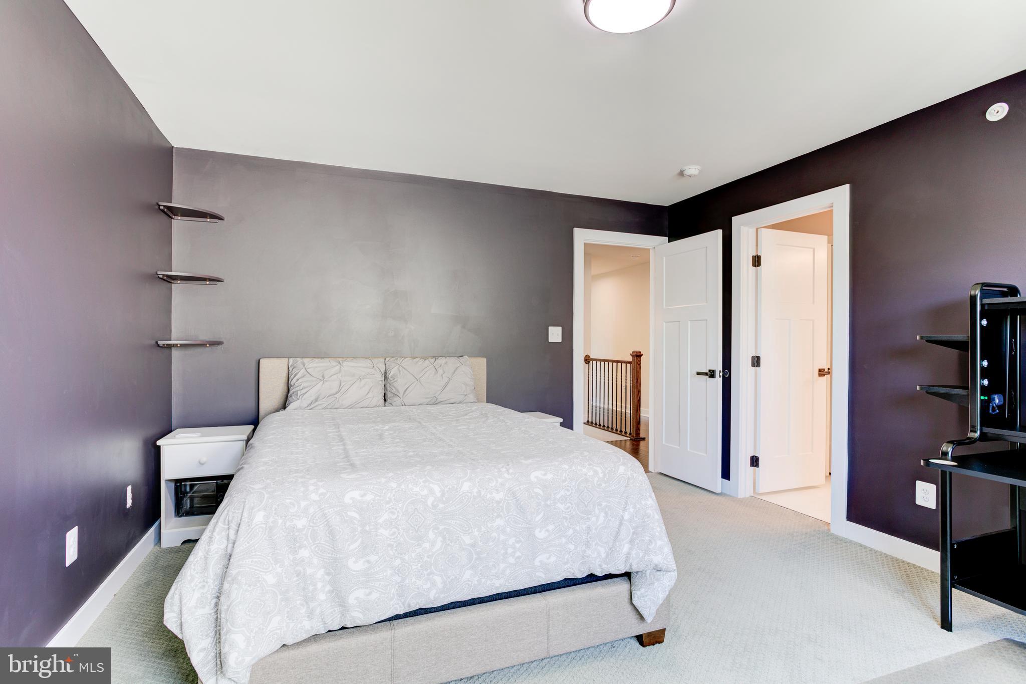 2346 Sweet Pepperbrush Loop Dumfries, VA 22026 - Photo 49 of 84 a spacious bedroom with a bed and a cabinets