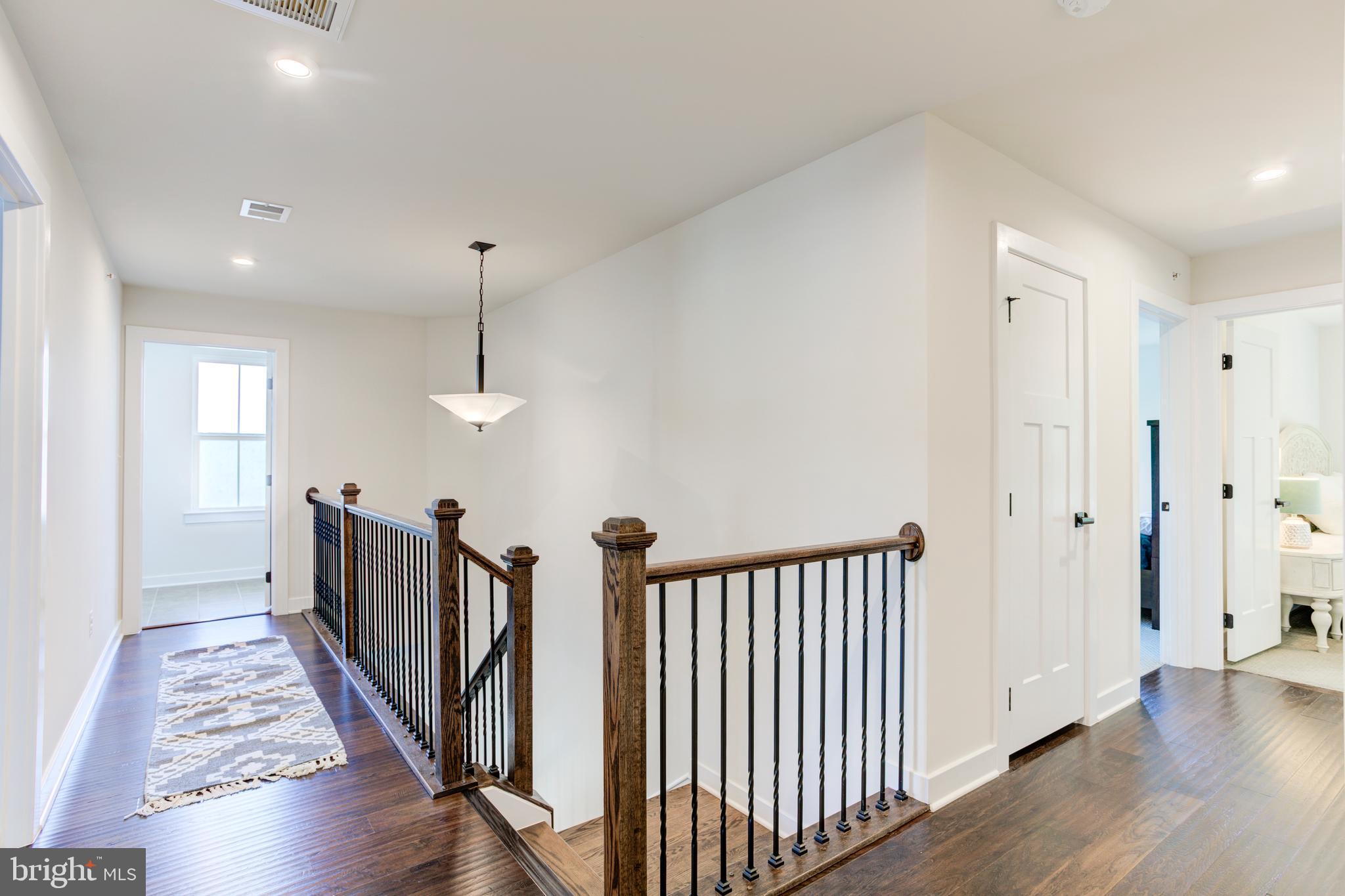 2346 Sweet Pepperbrush Loop Dumfries, VA 22026 - Photo 55 of 84 a view of a hallway with wooden floor and windows