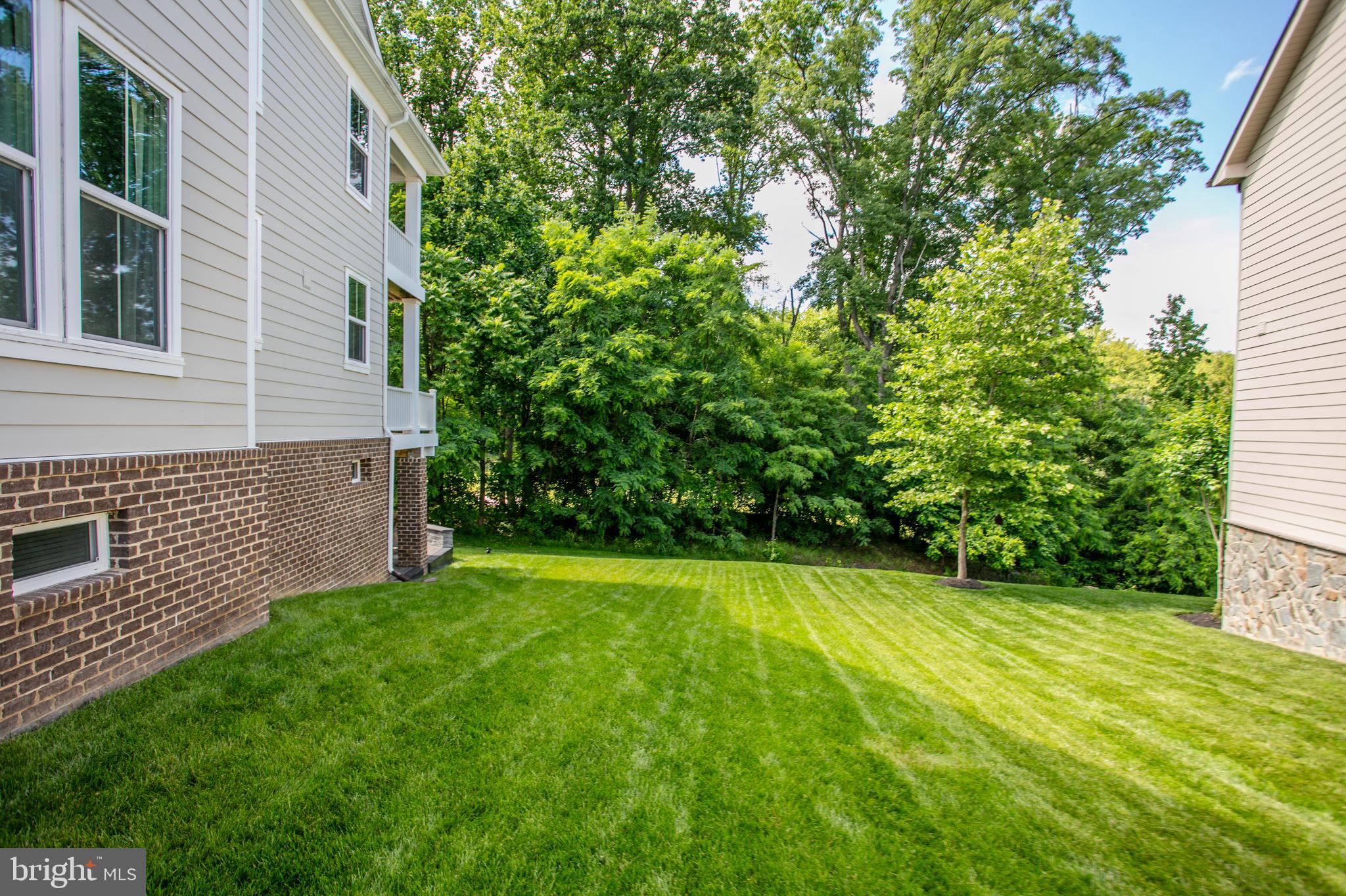 2346 Sweet Pepperbrush Loop Dumfries, VA 22026 - Photo 68 of 84 a view of a backyard with a small cabin