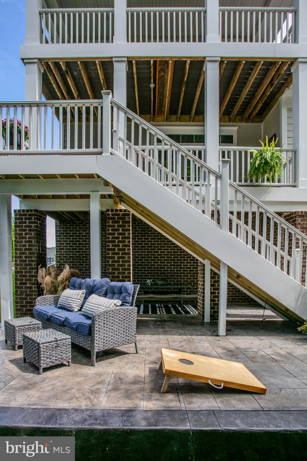 2346 Sweet Pepperbrush Loop Dumfries, VA 22026 - Photo 76 of 84 a view of a patio with couches chairs and wooden floor