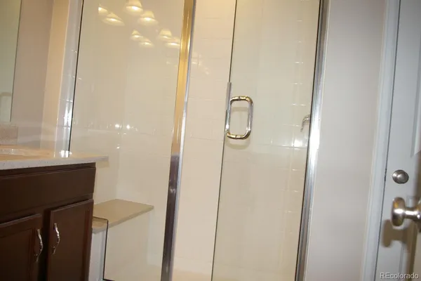 a bathroom with a shower and a sink