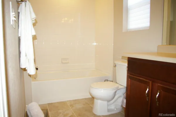 a bathroom with a toilet sink and shower