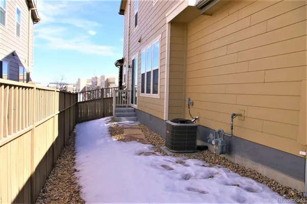 a view of a patio with wooden fence