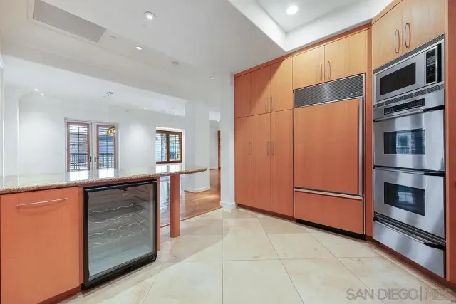 a kitchen with stainless steel appliances a refrigerator and cabinets