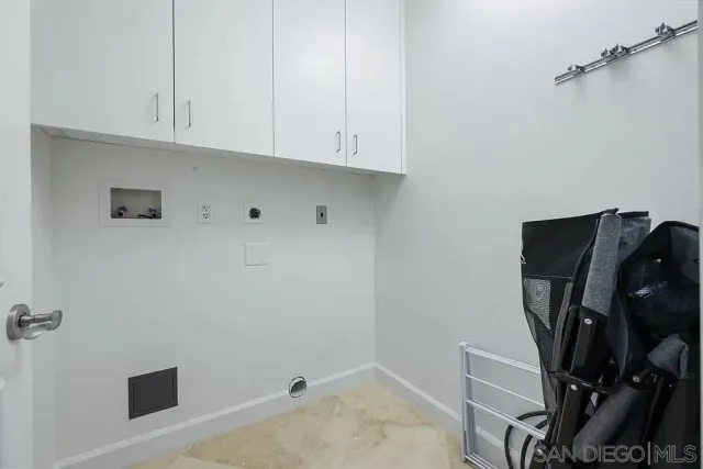 a view of storage and utility room with wooden floor