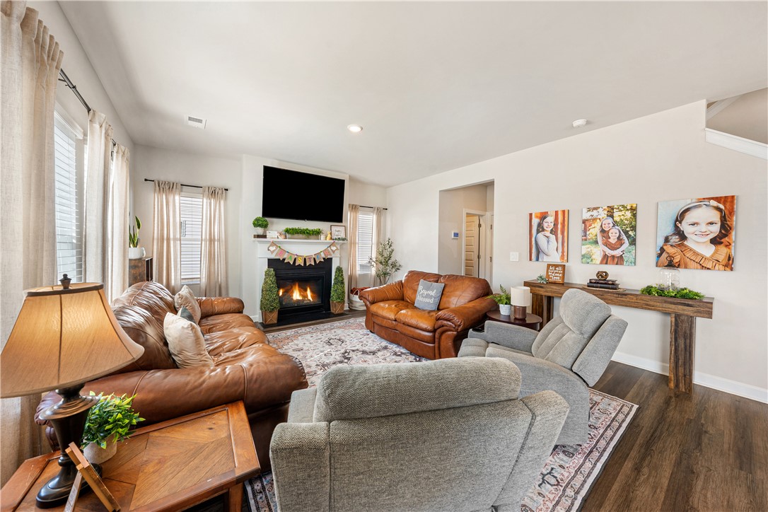 203 Maxwell Drive Easley, SC 29642 - Photo 13 of 34 This inviting living room showcases a beautiful fireplace, ideal for relaxed gatherings and quiet evenings.