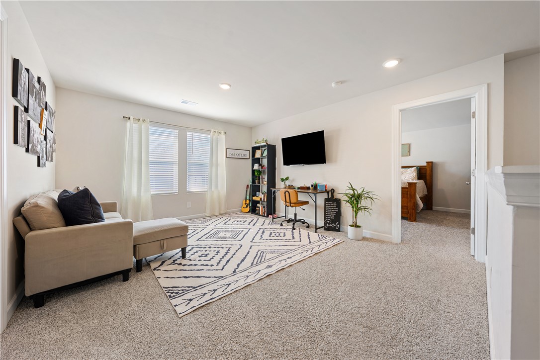 203 Maxwell Drive Easley, SC 29642 - Photo 20 of 34 This versatile living space offers bright illumination and comfortable carpeting, ideal for relaxation or productivity.