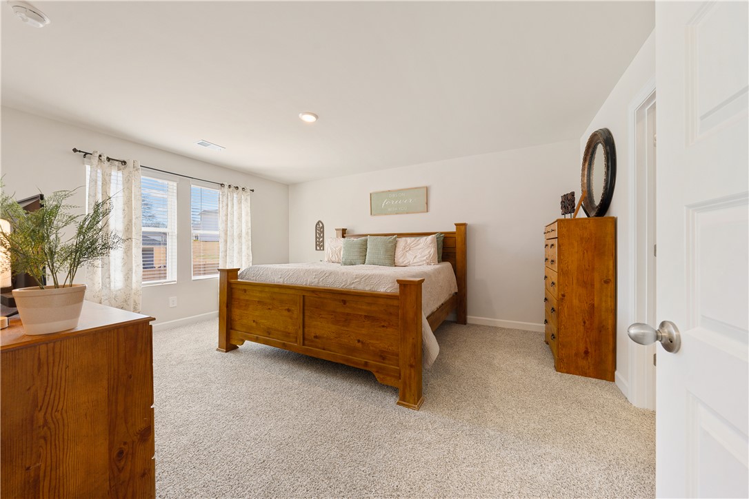 203 Maxwell Drive Easley, SC 29642 - Photo 21 of 34 This spacious primary bedroom features soft carpeting and ample natural light, creating a serene retreat.