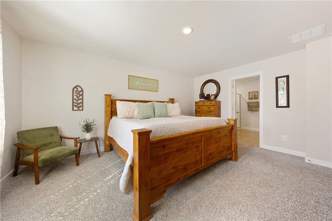 203 Maxwell Drive Easley, SC 29642 - Photo 22 of 34 This spacious bedroom offers a tranquil retreat with a convenient ensuite bathroom access.