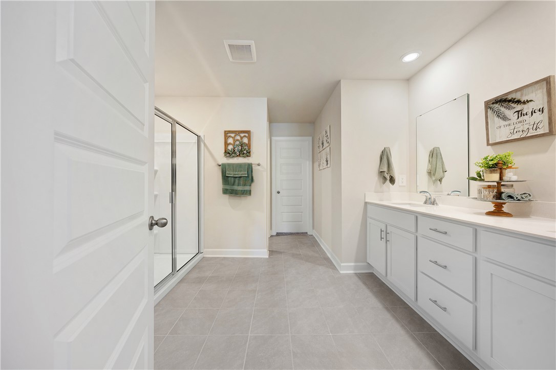 203 Maxwell Drive Easley, SC 29642 - Photo 23 of 34 This spacious bathroom features modern amenities and a bright, inviting atmosphere.