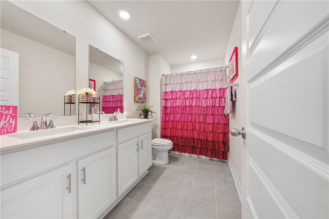 203 Maxwell Drive Easley, SC 29642 - Photo 29 of 34 This bright bathroom features a spacious dual vanity and contemporary tile flooring.
