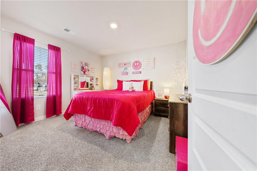 203 Maxwell Drive Easley, SC 29642 - Photo 30 of 34 This cozy bedroom features plush carpeting and abundant natural light, creating a bright and inviting atmosphere.
