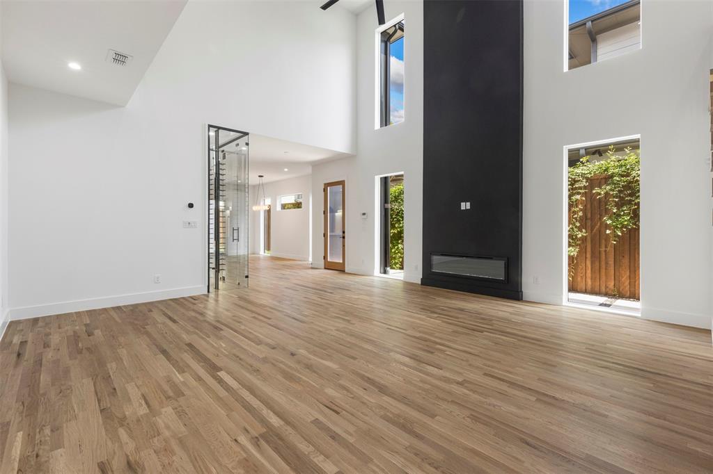 5611 Ellsworth Avenue, Unit 102 Dallas, TX 75206 - Photo 8 of 25 Unfurnished living room featuring light wood-