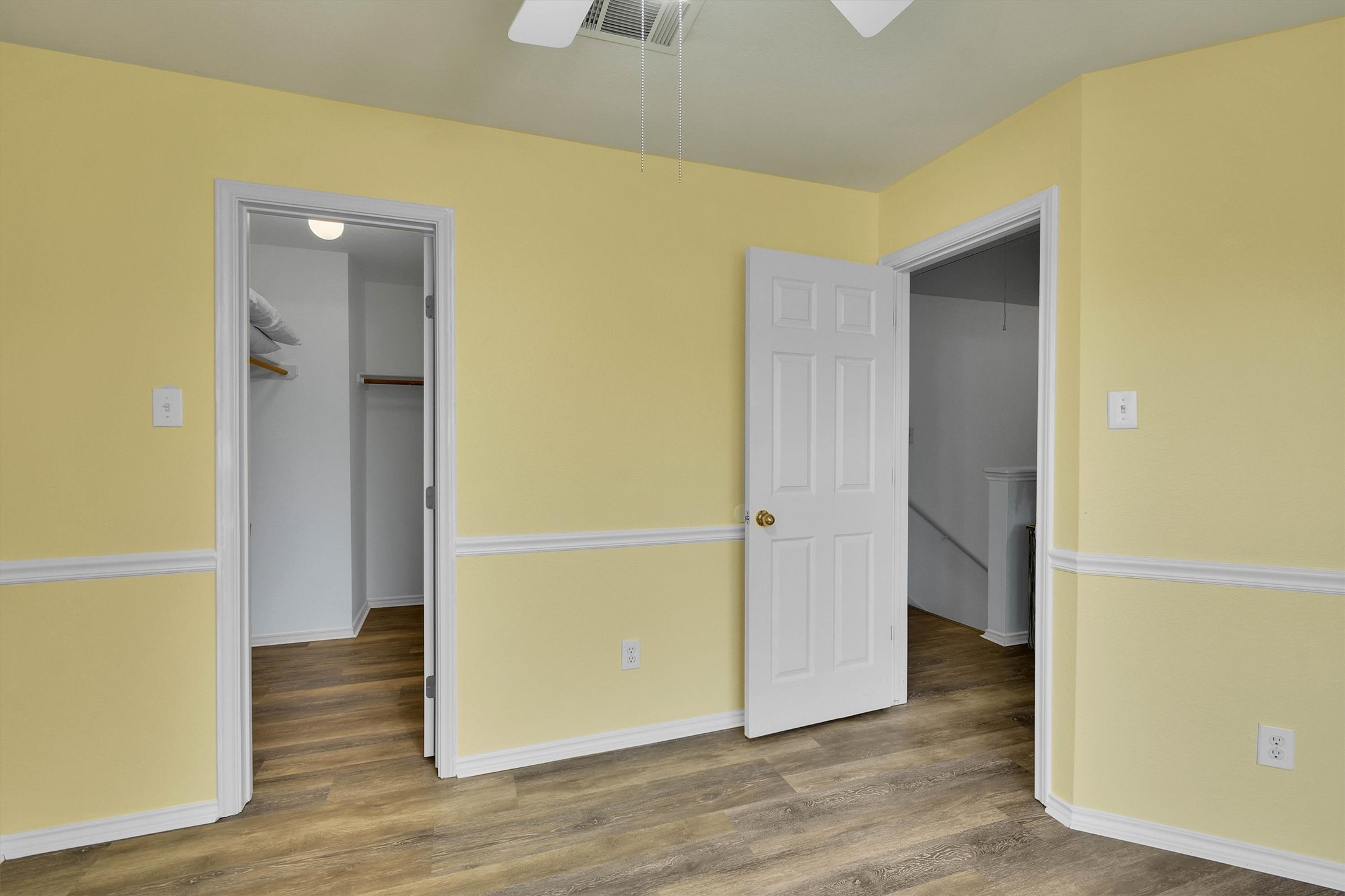 92 Verde Ranch Loop Leander, TX 78641 - Photo 18 of 37 Unfurnished bedroom featuring a ceiling fan, wood finished floors, and a spacious closet