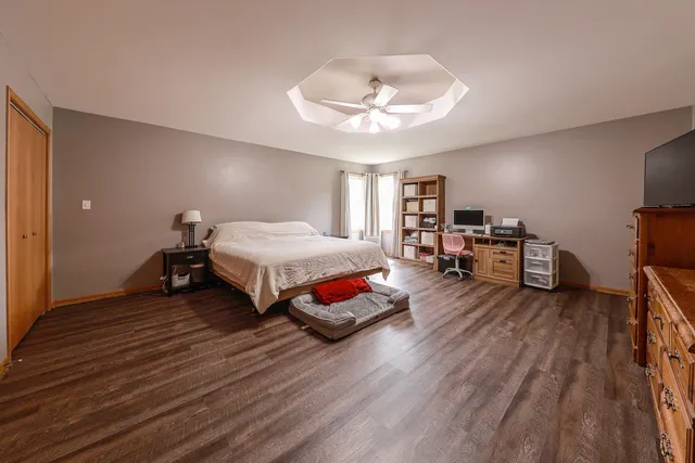 a bedroom with furniture and a wooden floor