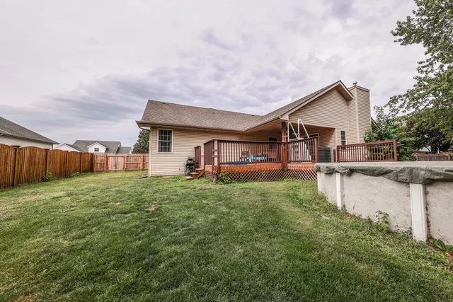 a view of a house with pool and a yard