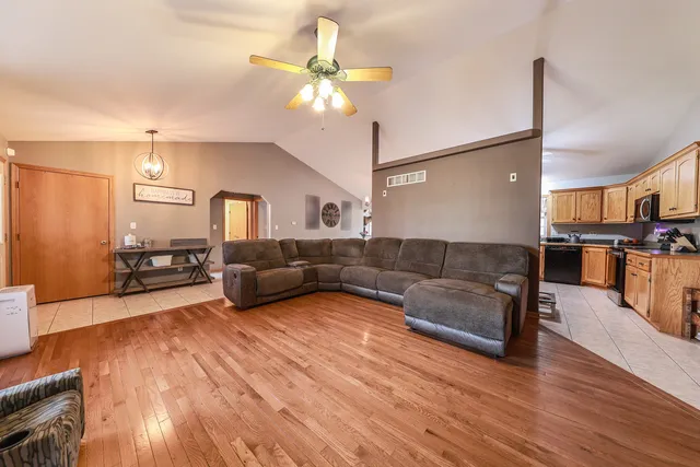 a living room with furniture and kitchen view