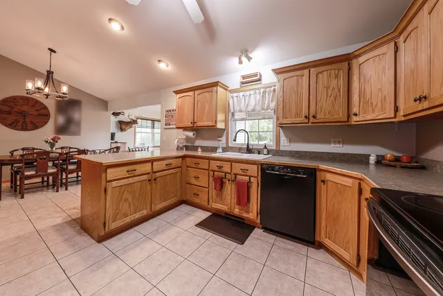 a kitchen with a sink stove top oven and cabinets