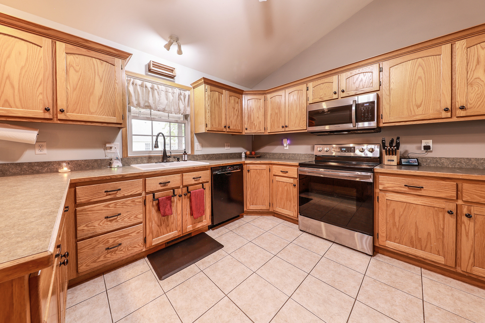 1115 Crystal Lane Diamond, IL 60416 - Photo 5 of 17 a kitchen with stainless steel appliances granite countertop a stove sink microwave and cabinets