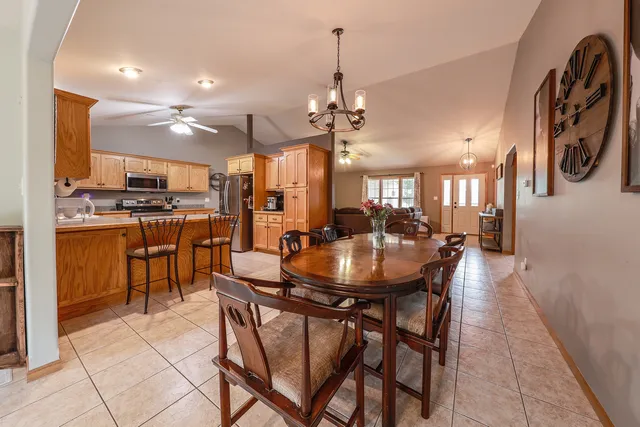 a view of a dining room with furniture and a chandelier